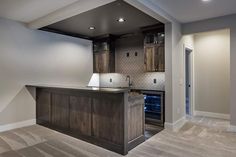 a kitchen with an island in the middle and cabinets on both sides that are open