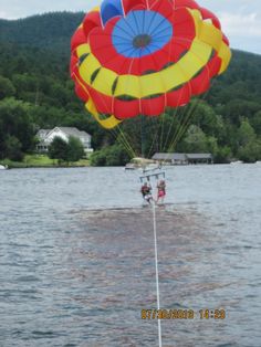 two people are parasailing in the water