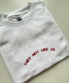 They Not Like Us, Embroidered T-shirt, Monogram, Funny T-shirt, Unisex, SHIPPING INFO: FREE UK DELIVERY are sent as 1st Class (1-2 Working days) UK EXPRESS (Next day delivery) this is an extra cost at checkout Europe sent as International Tracked (Expected 3-5 working days) Worldwide sent as International Tracked (Expected 5-7 working days) EMBROIDERY THREAD: POLYESTER T-SHIRT: 100% COTTON (WHITE 170 GSM) (OTHER COLS 180 GSM) SWEATSHIRT: 80% COTTON, 20% POLYESTER (WHITE + HEATHER GREY 260 GSM) ( T Shirt Embroidery, Embroidery Tshirt, Grey T Shirt, Embroidered Tshirt, Funny T Shirt, Funny T, Gray Tshirt, Embroidery Thread, Funny Tshirts