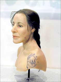 a female mannequin head with a tattoo on it's chest and shoulder