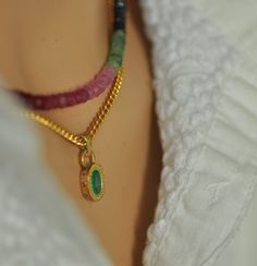 "18K Gold Emerald Pendant Set with gemstones Bead unique necklace. The pendant: 18k yellow gold oval pendant with oval green Emerald stone and 7 small Ruby stones set aside. **  18k yellow gold **  7 small 1.1 Ruby stones **  Oval 7 * 5 Emerald stone  **  Two large gold links 0.8 - 0.9 m\"m The handmade unique gold pendant that I made especially for this green oval Emerald.  On the side of the pendant, I set 7 red Ruby that makes this pendant even more beautiful and special. The oval emerald is set in a unique setting with gold dots all around. The Small Ruby stones on the side of the pendant are set with small circles around. The pendant has an antique-style look.                                                      The gemstone necklace is Emerald, Ruby and Sapphires beads necklace. The Spiritual Oval Necklace With Gemstone Accents, Unique Gold Pendant, Ruby Pendant Set, Emerald Pendant Set, Gem Necklaces, Multi Coloured Necklaces, Green Oval, Fancy Gifts, Ruby Pendant