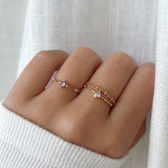 This dreamy, ultra charming ring features a double band that highlights an iridescent teardrop crystal and finished with a beaded crystal detailed band. MATERIALS: Cubic zirconia 14k Gold, Rose Gold, Rhodium Plated, Brass  Tarnish-resistant protective coating Dainty Adjustable Ring For Promise, Dainty Adjustable Rings For Promise Occasion, Dainty Crystal Toe Ring For Promise, Dainty Adjustable Midi Rings For Promise, Dainty Open Crystal Promise Ring, Delicate Promise Jewelry, Dainty Hypoallergenic Stackable Promise Rings, Dainty Adjustable Crystal Promise Ring, Adjustable Dainty Crystal Promise Ring