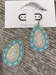 ALL ITEMS ARE MADE TO ORDER AND DONE IN ORDER OF PURCHASE  Sparkling silver & turquoise beaded teardrop earrings with white lined and silver seed beads, with a sparkling beaded border to make them really stand out  These stunning earrings have a stainless steel post earring, white leather backing making them comfortable to wear, they measure 1 1/2" inches wide & 2" inches long. These will sparkle and shine in natural or artificial light, would be a fabulous earring for any type of wedding as well as every day with jeans. I am First Nation, Plains Cree so you are buying authentic items made by myself. Turquoise Silver Beaded Dangle Earrings, Bohemian Light Blue Teardrop Earrings, Handmade Turquoise Drop Jewelry, Beaded Teardrop Crystal Earrings, Blue Teardrop Jewelry With Silver Beads, Beaded Teardrop Earrings For Gift, Silver Teardrop Beaded Jewelry, Beaded Teardrop Earrings As Gift, Turquoise Earrings With Silver Round Beads