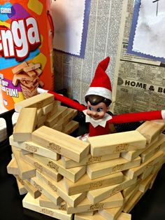 an elf is sitting in a pile of wood blocks