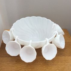 a white bowl sitting on top of a wooden table