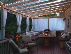 an outdoor living area with patio furniture and string lights