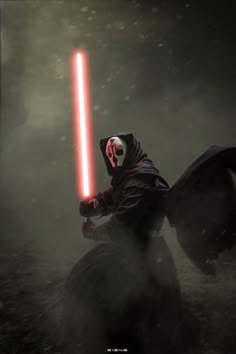 a person in a costume holding a light saber