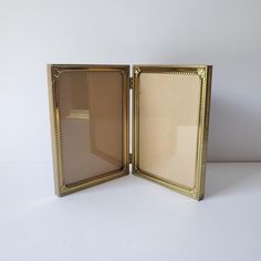 an open gold frame on a white surface