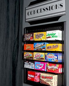 a vending machine that has some candy on the front and side of it,