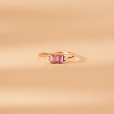 Caresha Everything looks better in pink. The sapphire stone is associated with royalty and is believed to attract abundance, blessings, and gifts. The sapphire gems on this ring have a bezel cut for a simple yet elegant look. Available in Yellow Gold, White Gold, and Rose Gold. - Handmade- Solid Gold - Natural Diamonds and Pink Sapphire- G Color, SI Quality Diamonds- Total Sapphire Carat Weight: 0.45 ctw- Total Diamond Carat Weight: 0.06 ctw- Setting Height: 2.8 mm- Band Size: 1.45 mm All pieces Classic Pink Sapphire Diamond Ring As Gift, Elegant Pink Sapphire Ring With Brilliant Cut, Pink Brilliant Cut Sapphire Ring As Gift, Pink Sapphire Ring With Ethical Diamonds, Pink Brilliant Cut Sapphire Ring Gift, Pink Sapphire Engagement Ring, Pink Sapphire Ring Engagement, Sapphire Diamond Engagement, Diamond Sapphire Engagement Ring