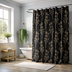 a black and gold shower curtain in a bathroom next to a bathtub with a white rug on the floor