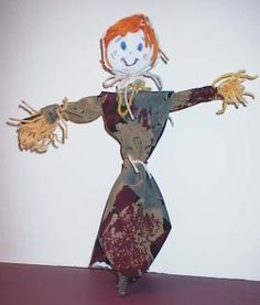 a paper doll with red hair and hands in the air