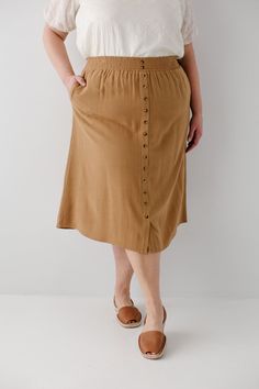 Start your day in style with the 'Greta' Skirt! This midi length, linen-blend skirt is light and airy for spring and summer and features button-down detailing for a fun touch. Pair the 'Greta' with all your favorite tops for Sunday morning or a day at the farmer's market! 30% Linen 70% Rayon Hand Wash Cold Hang to Dry Spring Midi Bottoms With Button Closure, Spring Daywear Rayon Maxi Skirt, Spring Vacation Button-up Bottoms, Knee-length Summer Bottoms With Buttons, Casual Midi Skirt With Button Closure For Day Out, Midi Length Bottoms With Button Closure For Day Out, Casual Midi Bottoms With Button Closure For Day Out, Spring Relaxed Skirt With Button Closure, Spring Long Skirt With Buttons