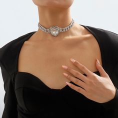 Silver-plated choker necklace featuring sparkling crystals and cubic zirconia. Charming heart-shaped pendant. Chain : 13.19" L with 4.33" extender Pendant : 1.42" W x 1.42" H Lobster claw clasp Silver-plated copper / crystal / cubic zirconia Metal Heart Pendant Choker, Heart Cut Cubic Zirconia Party Necklace, Valentine's Day Party Heart Necklace In Cubic Zirconia, Party Heart Choker Necklace With Clavicle Chain, Elegant Metal Heart Choker Necklace, Party Choker With Heart Pendant, Crystal Heart Pendant Necklace For Party, Valentine's Day Party Crystal Heart Necklace, Elegant Heart Necklace With Rhinestones For Parties