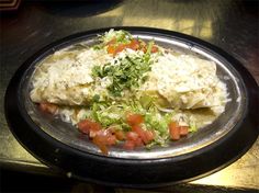 some food is sitting on a metal plate