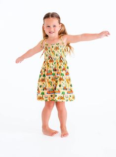 Your little one will be safari-ready in this smocked birdie dress. Crafted with a blend of viscose from bamboo and spandex, this dress is both comfortable and stylish. This blend offers a lightweight and breathable fabric, perfect for warm-weather outings. [pajamas, pajama party, toddler girl style, toddler boy style, bloomers outfit, baby clothes, baby shoes, baby fashion, kids fashion, baby girl clothes] Cute Ruched Mini Dress For Vacation, Smocked Bodice Sundress For Vacation, Playful Fitted Smocked Dress, Cute Summer Sundress With Smocked Bodice, Flowy Smocked Bodice Dress For Vacation, Flowy Vacation Dresses With Smocked Bodice, Flowy Smocked Sundress For Vacation, Summer Beach Sundress With Elastic Waistband, Fitted Cotton Smocked Dress With Elastic Waistband