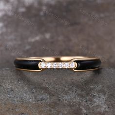 a black and gold wedding band with diamonds