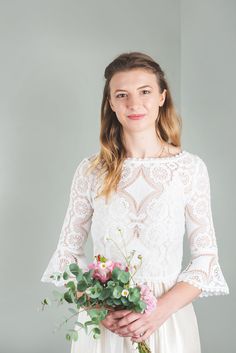 a woman holding a bouquet of flowers in her hands