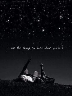 two people laying on the ground under stars in the night sky with their feet up