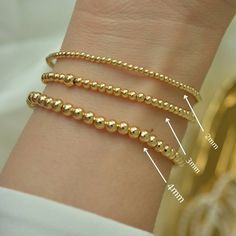 ** BUY ANY THREE (3) ITEMS AND GET 20%OFF ON YOUR ENTIRE PURCHASE ** Gold Bead Bracelet, Beaded Bracelet, Gold Bracelet, 18K Gold Filled Bead Bracelet, Stacking Bracelet 2mm 3mm 4mm, Dainty Bracelet Classic 18k gold-filled bead bracelet is a perfect addition to a dainty stack this spring/summer season. The beads are strung on a premium stretch cord. SOLD BY ONE BRACELET ITEMS DETAILS: Water Resistant -Nickel-free - Allergy-free - Hypoallergenic - 18K gold-filled bead bracelets - round bead size Minimalist Stackable Beaded Bracelets, Minimalist Stackable Bracelets With Round Beads, Dainty Stackable Round Bead Bracelets, Dainty Stackable Bracelets With Round Beads, Dainty Hypoallergenic Bracelets With Round Beads, Minimalist Hypoallergenic Beaded Round Bracelets, Minimalist Hypoallergenic Round Beaded Bracelets, Minimalist Hypoallergenic Beaded Bracelet, Flexible Bracelets With Tiny Beads As A Gift