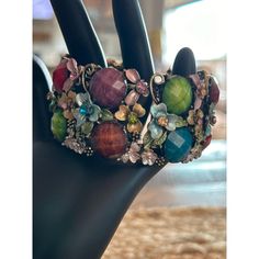 Add some bling to your wrist and make your friends jealous with this vibrant cuff bracelet. It's like a garden party on your arm! * Multicolored gemstones * Floral accents * Adjustable cuff design * Durable material * Easy to wear Bohemian Metal Bracelets For Spring, Spring Bohemian Metal Bracelets, Spring Bangle Beaded Bracelets, Vintage Multicolor Stone Bracelets, Bohemian Multicolor Gemstone Cuff Bracelet, Spring Bohemian Bangle Cuff Bracelet, Vintage Jewelry For Spring Party, Multicolor Metal Bracelets With Stones, Green Bracelets For Spring Party