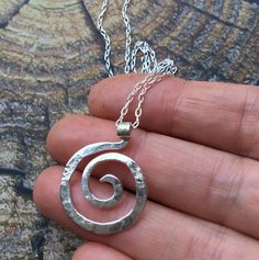 "SIZE: 1\" x 3/4\" (Available in 16\" or 18\" length) This tiny spiral pendant is inspired by the graceful spirals of the nautilus. Each spiral is hand shaped, hammered with my signature textured from my antique anvil. The texture comes from years of history, transferring every nick, dent and cranny which is transferred to the metal with every hammer stroke Great for every day, this tiny spiral pendant hangs from a delicate sterling chain with spring clasp and daisy loop giving it that extra lit Sacred Spiral, Spiral Jewelry, Celtic Spiral, Ring Holder Necklace, The Nautilus, Spiral Pendant, Spiral Necklace, Spiral Ring, Pendant Ring