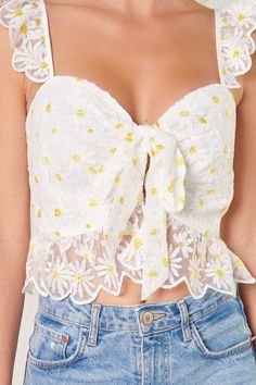 Feel the sun on your skin in this charming ruffled crop top. Embroidered daisies shape this cropped top, featuring ruffle straps that join a fitted bodice with a sweetheart neckline. It maintains a shapely fit with a peplum ruffle along the waistline. A tie front detail sits at the heart of the neckline to create a flirty flair. Wear it with your favorite high rise bottoms for a finished look.- Hook and eye closure- Tie front detail- Embroidered- Peplum- Color: White FloralSize + Fit - Model is White Floral Crop Top, Feminine Crop Top With Ruffled Straps, White Fitted Crop Top With Floral Embroidery, White Sleeveless Floral Print Crop Top, White Floral Print Feminine Crop Top, Playful White Floral Print Top, Ruffled Crop Top, Striped Peplum Top, Spandex Top