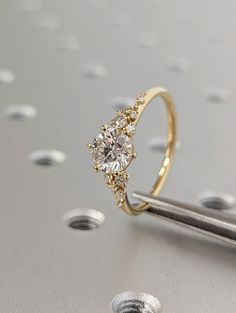 a close up of a diamond ring on a table