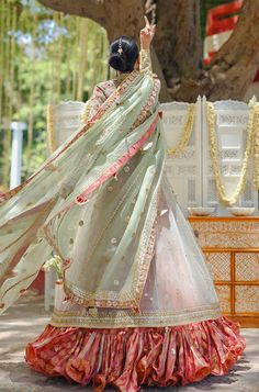 A tulle peshwas, featuring zardoze and resham embroidery, is paired with a salmon pink brocade lehnga and choli. Paired with a mint green organza dupatta accentuated with gota details and tassels. Festival Reception Anarkali Set With Sheer Dupatta, Festival Anarkali Set With Sheer Dupatta For Reception, Pista Green Traditional Wear With Gota Work For Reception, Pista Green Sharara With Sheer Dupatta For Navratri, Pista Green Raw Silk Sharara With Dupatta, Pista Green Organza Choli With Cutdana, Pista Green Choli With Gota Work In Traditional Drape, Pista Green Floor-length Dupatta With Gota Work, Pista Green Traditional Wear With Sheer Dupatta For Navratri