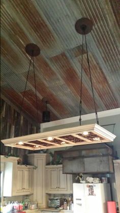 a kitchen with wooden ceiling and white cabinets