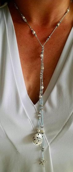 Always bring a reminder of the ocean with you. This silk, hand knotted lariat has two beautiful focal pieces, a starfish and sand dollar. Surrounding them are crystals and fresh water pearls. The lariat is created on light blue silk. Each lariat is created upon order. There may be slight variations in the beads. This lariat does not have a clasp. Simply criss cross and flip one end over to make a Y and complete the necklace. Once worn, lariats look beautiful and do not tangle. You can accomplish different looks by criss crossing in different places.  The necklace measures 34 inches.  Each piece comes with a card that says "Created especially for you." (photo 2) If you would prefer a different card, please look at the listing for cards to choose one that suits your needs. Include the card c Elegant Lariat Necklace With Adjustable Length For Festivals, Elegant Long Lariat Necklace For Festivals, Bohemian Lariat Necklace With Sliding Knot, Elegant Lariat Necklace With Adjustable Cord As Gift, Elegant Lariat Necklace For Festivals, Bohemian Lariat Necklace With Adjustable Cord, Handmade Adjustable Lariat Necklace, Adjustable Lariat Long Necklace, Elegant Adjustable Lariat Necklace For Festivals