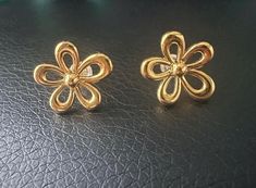 Add a touch of nature-inspired elegance to your collection with these beautiful 18k gold floral earrings. The delicate daisy flower design is perfect for any occasion, bringing a hint of springtime charm to your look. Lightweight and comfortable, these earrings are sure to become a favorite accessory. These earrings comes with gel push backs.  It comes with a matching pendant. This listing is only for the earrings. Please see the other listing for the pendant.  Dimensions: 0.67'' x 0.63'' x 0.18 Yellow Gold Flower Charm Earrings, Yellow Gold Diamond Flower Earrings, Dainty Flower Earrings For Formal Events, Classic Flower Earrings For Formal Occasions, Elegant Spring Earrings For Anniversary, Formal Yellow Gold Flower Earrings, Yellow Gold Flower Earrings With Charm, Luxury Yellow Gold Flower Earrings, Elegant Yellow Gold Clip-on Flower Earrings