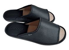 Men home slippers made of natural leather in black. These open-toe slip on sandals allow your feet to breathe freely and provide maximum comfort, and they also feature unique eyelets on the upper for an elegant look. Additionally, in the heel area there is a leather insert with foam, which guarantees comfort and stability, preventing slipping and acting as a shock absorber, protecting the feet against injuries while walking. The sole is made of EVA foam, which increases the comfort of wearing th Black Open Toe Slippers With Leather Sole, Black Open Toe Slippers With Leather Footbed, Black Slide Mules With Leather Footbed, Black Leather Slide Slippers, Black Leather Slippers With Removable Insole, Black Leather Slippers With Leather Lining, Black Leather Slide Mules, Black Slide Mules With Removable Insole, Black Open Toe Mules With Rubber Sole