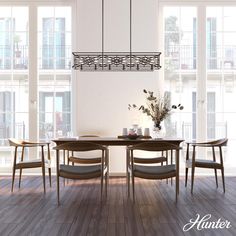 a dining room table and chairs in front of large windows