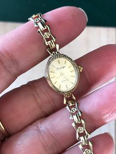 "🍀A Fine Antique Ladies Solid 9ct GOLD. 🍀9ct solid Gold bracelet.  🍀Winds and sets well and timekeeping Good.  🍀Serviced , Quartz  🍀9ct Case and 9ct gold watch band , full English hallmark  From 1970s  top cosmetics condition: 98%new(minty)  Case size 18-20mm including winding button. Collection grade! And daily wear  ship by Speed post worldwide* with no extra cost ^^ Why Vintage/ Antique jewelry & watches? 🌹Timeless Elegance:  offering a blend of vintage charm and functional sophistication. 🌹The unique and enduring appeal of owning a piece of history & heritage at your fingertips 🌹Each jewelry piece is a testament to meticulous craftsmanship, showcasing the natural brilliance the historical significance of designs.-Never scroll through online inventory at a sea of clones or copie Classic Oval Gold Watches, Oval Gold Watches For Gifts, Gold Oval Watches As Gifts, Gold Oval Watches For Gift, Gold Watches With Jubilee Bracelet For Anniversary, Hallmarked 14k Yellow Gold Watches, Gold Watch With Jubilee Bracelet For Anniversary, Gold Antique Watch With Jubilee Bracelet, Antique Gold Watch With Jubilee Bracelet