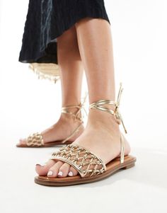 Shoes by ALDO Give your feet some airtime Knotted strap Tie-leg fastening Open toe Flat sole Gold Strappy Sandals For Summer, Gold Flat Heel Sandals For Spring, Adjustable Gold Sandals With Round Toe, Gold Ankle Strap Sandals For Beach, Adjustable Gold Sandals For Festival, Gold Ankle Strap Sandals For Vacation, Gold Strappy Sandals For Vacation, Ankle Tie Lace-up Sandals For Spring Festival, Gold Adjustable Sandals For Beach