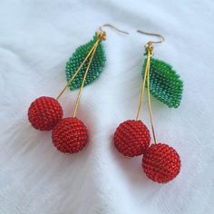 Stand Out with These Playful Cherry Earrings! Who's this for? Looking for a unique accessory to add a touch of personality to your outfit? These cherry earrings are the perfect choice for anyone who loves: Fun and playful jewelry Bright and vibrant colors Unique and eye-catching designs Comfortable and lightweight accessories Characteristics: Handmade with high-quality Czech glass beads Features vibrant red and green cherries Lightweight and comfortable to wear Gold-plated findings for a touch of elegance Versatile and can be paired with any outfit Why it's worth buying: Adds a pop of color and personality to any outfit Makes a perfect gift for a friend or loved one Crafted with attention to detail and high-quality materials Affordable and stylish Ready to add a touch of whimsy to your war Cherry Party Jewelry For Pierced Ears, Cherry Colored Earrings For Summer Party, Cherry Color Earrings For Summer Party, Trendy Handmade Cherry-colored Jewelry, Party Cherry Earrings, Cherry Dangle Earrings For Party, Cherry Color Dangle Earrings For Party, Playful Red Dangle Jewelry, Trendy Beaded Earrings For Gift