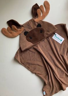 a brown moose costume laying on top of a white table