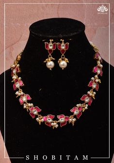 Set in the exquisite Jadau style, we present a necklace and earring set with pink and white stones in a classic design! Add a dash of vibrance to your jewelry collection with this blooming lotus neckpiece with consecutive unites to wrap around the neck like a choker or rest lower like a necklace! This set comes with a matching pair of earrings. Note: some of the images are enlarged for detailing, refer to the cover picture for a perspective on the size. Note: This set does not contain any precio Elegant Pink Bridal Necklace For Festive Occasions, Elegant Pink Bridal Necklace For Festive Seasons, Elegant Pink Necklace For Festive Occasions, Pink Jewelry For Formal Festive Occasions, Pink Formal Jewelry For Festive Occasions, Pink Kundan Necklaces As Gift, Pink Kundan Necklaces For Gifts, Pink Temple Jewelry Sets For Celebrations, Elegant Pink Kundan Necklace Gift