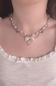 Looking for the perfect romantic necklace or girly jewelry to add a touch of elegance to your outfit? Our Pink Coquette Necklace is the ideal accessory! This dainty, feminine necklace features a charming bow and heart charm, complemented by soft, lustrous pearls in a delicate layered design. Perfect for adding a princess-inspired touch to any look, this necklace is a must-have for anyone who loves cute jewelry, vintage-inspired accessories, and girly gifts. Product Features: Color: Soft pink with a pearl accent, perfect for a girly aesthetic Design: Layered pearls with a cute bow charm and heart pendant Material: High-quality faux pearls and metal charm for a refined look Adjustable Length: Customizable to suit your style and fit comfortably Style: Dainty, romantic, and princess jewelry Oc Pear Necklace Outfit, Outfits With Pearl Necklace Classy, Pearl Necklace With Charm, Ingenue Jewelry, Coquette Accessory, Baddie Jewelry, Layered Pearls, Girly Necklace, Coquette Accessories