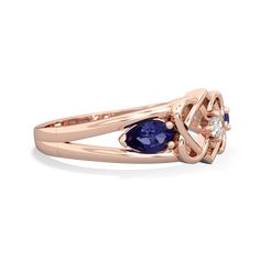 A stunning tribute to eternal love and timeless elegance. This exquisite 14K Rose Gold Celtic love knot ring with lab sapphire and  is more than a mere accessory - it's a symbol of unbreakable bonds and the infinite power of love. At the heart of this captivating design lies a radiant diamond, elegantly poised as the centerpiece, symbolizing the everlasting flame of love. Luxury Yellow Gold Rings With Lab-created Sapphire, Hearts Intertwined, Flame Of Love, Smoky Quartz Jewelry, Alexandrite Jewelry, Celtic Love Knot, Love Knot Ring, Blue Topaz Jewelry, Tanzanite Jewelry