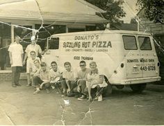 an old black and white photo of people in front of a pizza truck