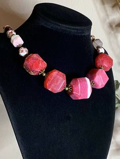 Necklace Length: 45.5+7cm (18+2.75in)*Weight: 133g Bracelet Length: 18.5+4cm (7.25+1.5in)* Weight: 26g Earrings Length: 33mm Weight: 6g Necklace “Wild Roses” - Porcelain Beads, Garnet, Pink Agate Raw Faceted Beads (biggest 26x26mm), Mother of Pearl, Brass Accessories.Pink Agate- a symbol of good luck. It is believed that the longer you wear pink agate, the better it works.Garnet- the stone with the most powerful energy. Helps to achieve goals and not lose enthusiasm. Needed by every traveler, bu Pink Faceted Bracelet Jewelry, Pink Faceted Jewelry Bracelet, Pink Faceted Beads Jewelry, Pink Jewelry With Faceted Round Beads, Pink Spiritual Jewelry With Faceted Beads, Adjustable Pink Stone Necklace, Spiritual Pink Jewelry With Faceted Beads, Pink Adjustable Necklace With Stones, Adjustable Pink Necklace With Stones