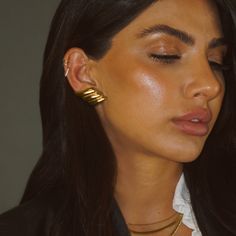 These earrings could adorn any festive ensemble with a hint of heavenly sophistication. Elevate your style with these limited edition gold twist earrings—a favorite among trendsetters. Crafted for lasting elegance and built to withstand your everyday, these statement pieces are a chic must-have for the season Water-resistant, sweat-proof, hypoallergenic and tarnish-free. You can work out in our durable jewelry, wear it to the beach, pool or even shower with it. Chic Gold Plated Clip-on Earrings For Formal Occasions, Trendy Formal Earrings With Plating, Chic Gold-tone Earrings For Gift, Chic Gold-tone Earrings Perfect As A Gift, Trendy Yellow Gold Earrings For Formal Occasions, Chic Gold-tone Gift Earrings, Chic Gold Earrings For Evening, Trendy Gold Ear Cuff With Matching Earrings, Modern Gold Ear Cuff For Party