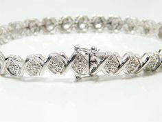 Silver bracelet sterling silver tennis bracelet linked with 26 'Xs' all with 4, 1mm round diamonds totaling 96 round cut diamonds (tested with a Presidium 2 tester).  Lovely and in excellent condition.  The bracelet is marked Thailand, makers mark and 925.  Please view all photos for accurate description and condition. Thank you for shopping with Indigo. Silver Tennis Bracelet, Art Nouveau Silver, Jade Bracelet, Bracelet Sterling Silver, Jade Beads, Jewelry Maker, Vintage Bracelets, Tennis Bracelet, Chain Link Bracelet