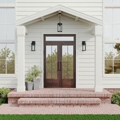 the front entrance to a white house with brick steps