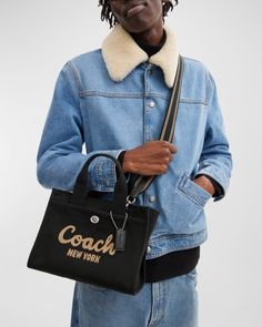 Coach leather and cotton cargo tote bag with logo across front     Top handles with logo tag, 4" drop    Detachable crossbody strap, 24"L    Can be worn as a top handle or crossbody bag     Zip top closure     Exterior, front slip pocket with turnlock closure and back slip pocket     Approx. 7.8"H x 10.3"W x 5"D    Spot clean    Imported Coach Tote Bags, Coach New York, Coach Logo, Coach Tote, Coach Leather, Lifestyle Products, My Bag, Zip Top, Style Icon