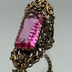 Vintage Art Deco Pink Glass Rhinestone Cocktail Ring Adjustable  Gold Tone  Floral Setting Ring's pad is 5,0 cm x 2,0 cm  We invite you to visit our stores Jewelry Store https://www.etsy.com/shop/TentationMillesime Clothing and Accessories Store https://www.etsy.com/shop/EntresolVoyage Every week we update our store and add new listings with astonishing goods. TERMS AND CONDITIONS All items are guaranteed to be 100% authentic and as described. Please note that all items are vintage, and not bein Art Deco Accessories, Deco Accessories, Art Deco Pink, Cocktail Art, Bridesmaid Gifts Jewelry, Pink Glass, Bridesmaids Gifts, Accessories Store, Cocktail Ring