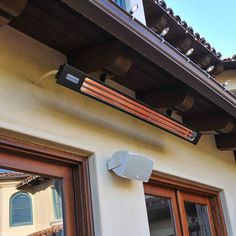 an outdoor heater mounted on the side of a house