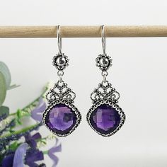 Handmade Artisan Crafted Filigree 925 Sterling Silver Earrings with Genuine Purple Amethyst Gemstones Material: 925 Solid Sterling Silver Amethyst Gemstones, 12 mm x 12 mm, Square, Faceted Earrings Length: 1.90 inches, Width: 0.65 inches Finishing: Oxidized and Polished Comes with a gift pouch and box Free Domestic Shipping Sterling Silver Filigree, Silver Work, Gift Pouch, Eye Jewelry, 925 Sterling Silver Earrings, Amethyst Gemstone, Handmade Artisan, Jewelry Gift Box, Purple Amethyst